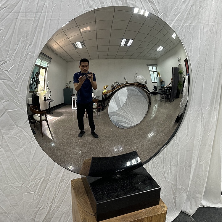 Close front view of the same mirror-polished stainless steel disc