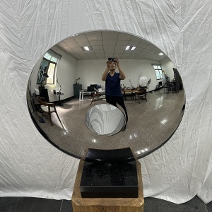 Front reflection view of the same mirror stainless steel disc sculpture