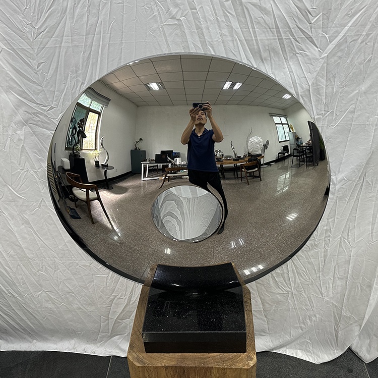 Front reflection view of the same mirror stainless steel disc sculpture