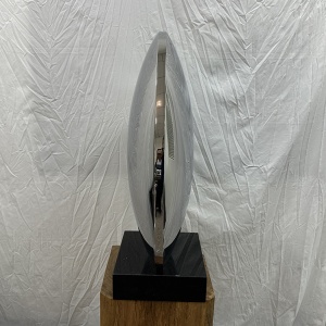 Side profile of the same mirror stainless steel disc sculpture