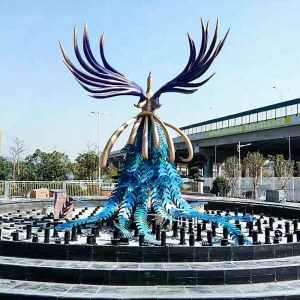 Rear view of the same outdoor stainless steel phoenix sculpture and fountain installation