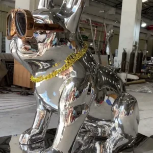 Side view of the same reflective dog sculpture showing the ear profile, glasses, seated body and base