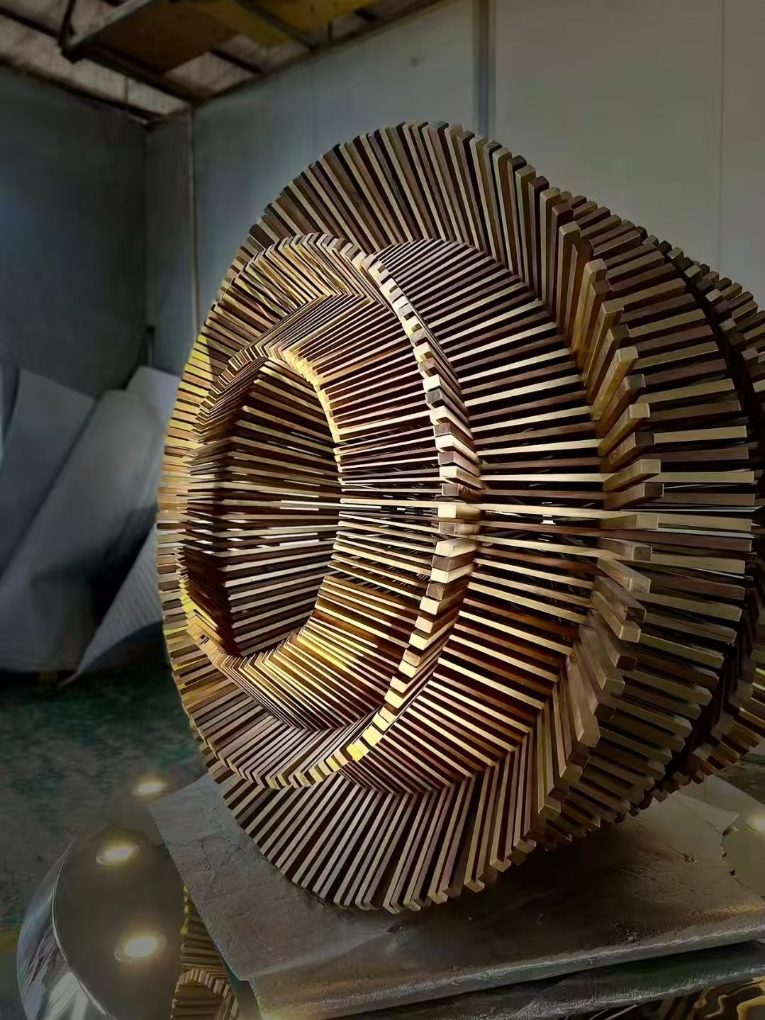 Close workshop view of the same bronze-tone layered stainless steel ring geometry