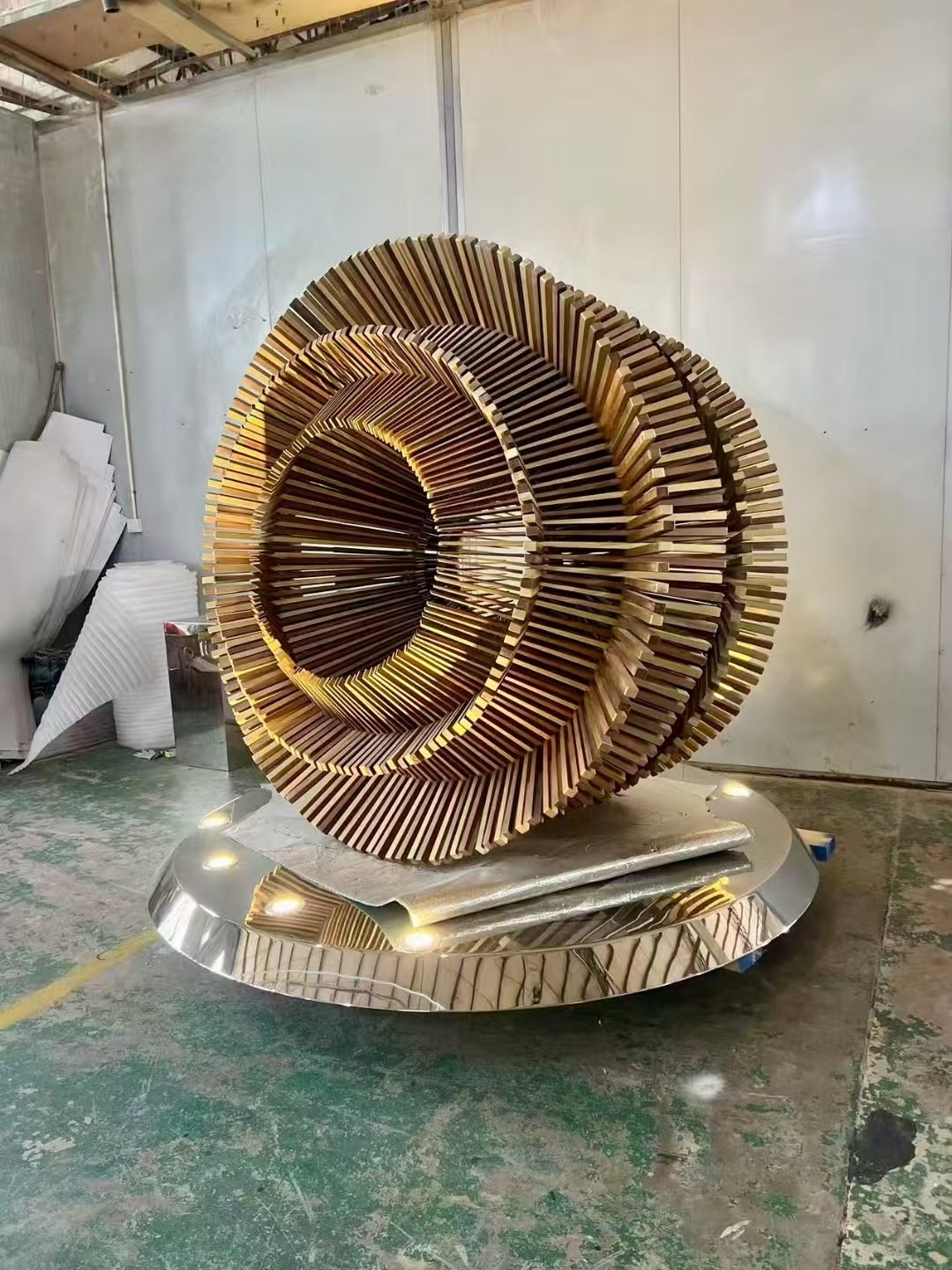 Second completed workshop view of the same layered ring sculpture and base