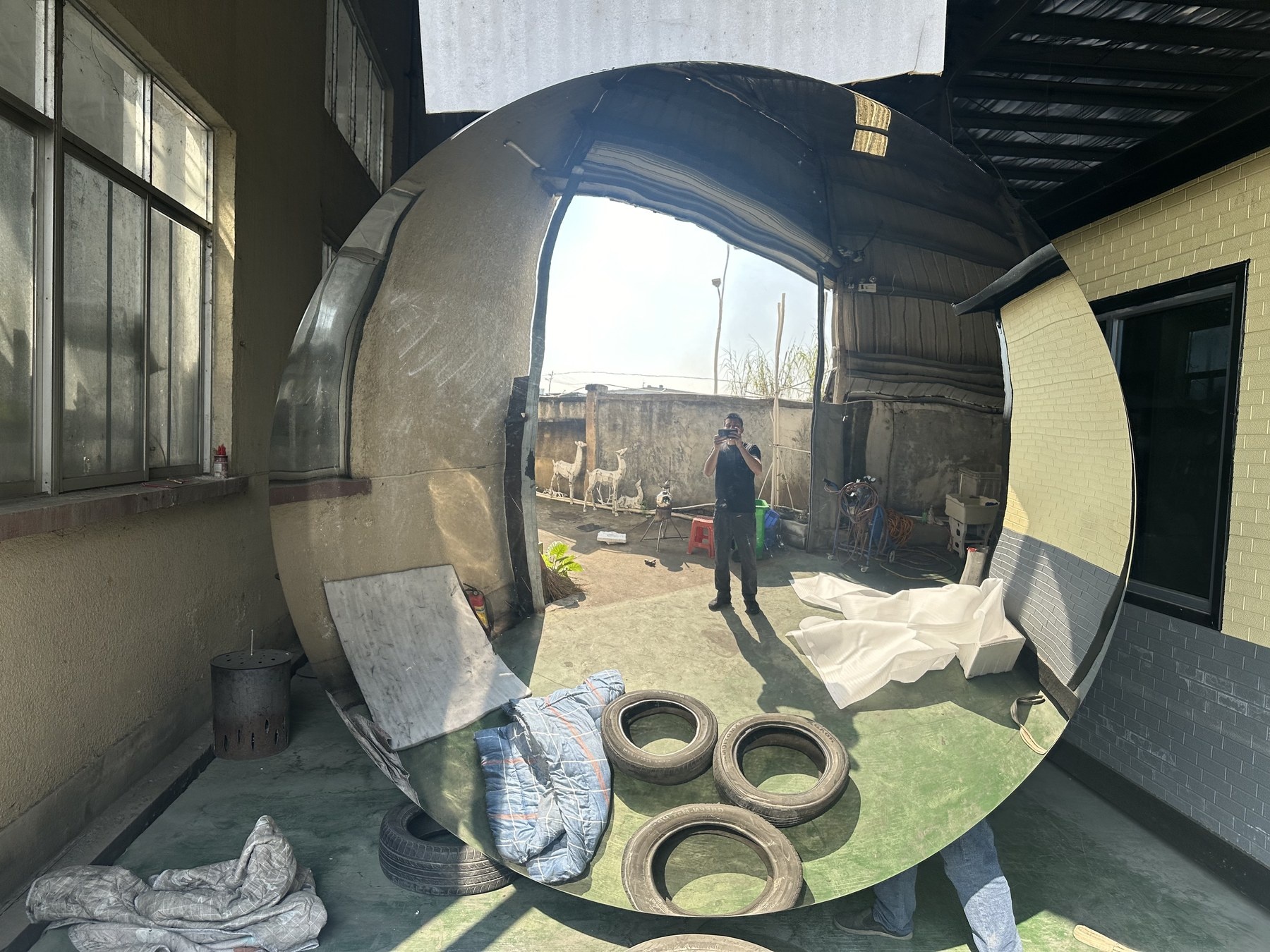 Front workshop view of a reflective stainless steel disc with visible perimeter and reflected interior