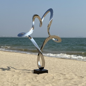 Second finished angle of the same mirror stainless steel abstract figure sculpture