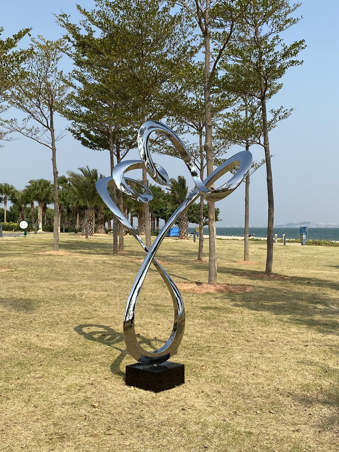 Installed landscape view of the same branching ribbon sculpture