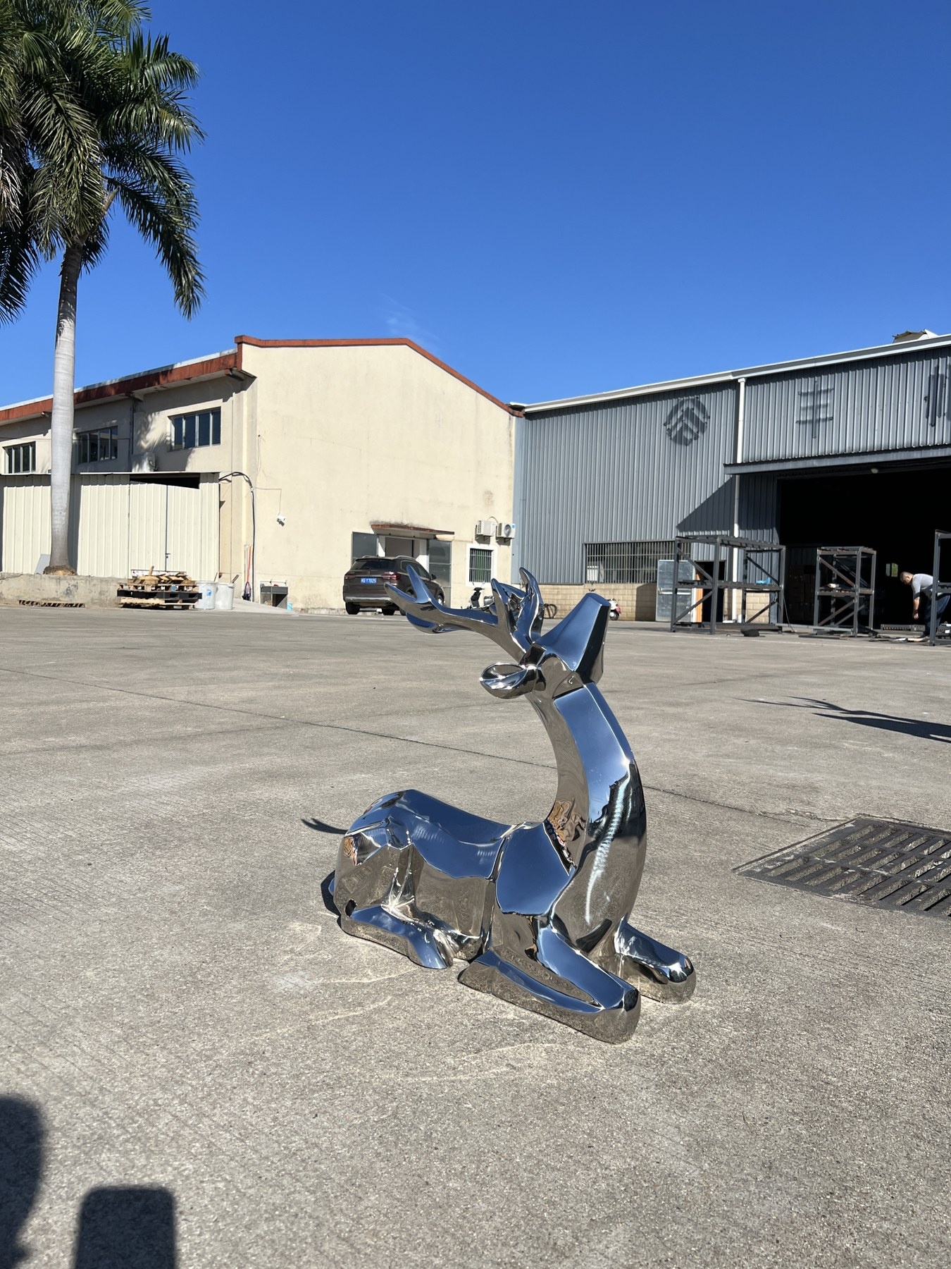 Reclining deer from the same mirror stainless steel family sculpture project