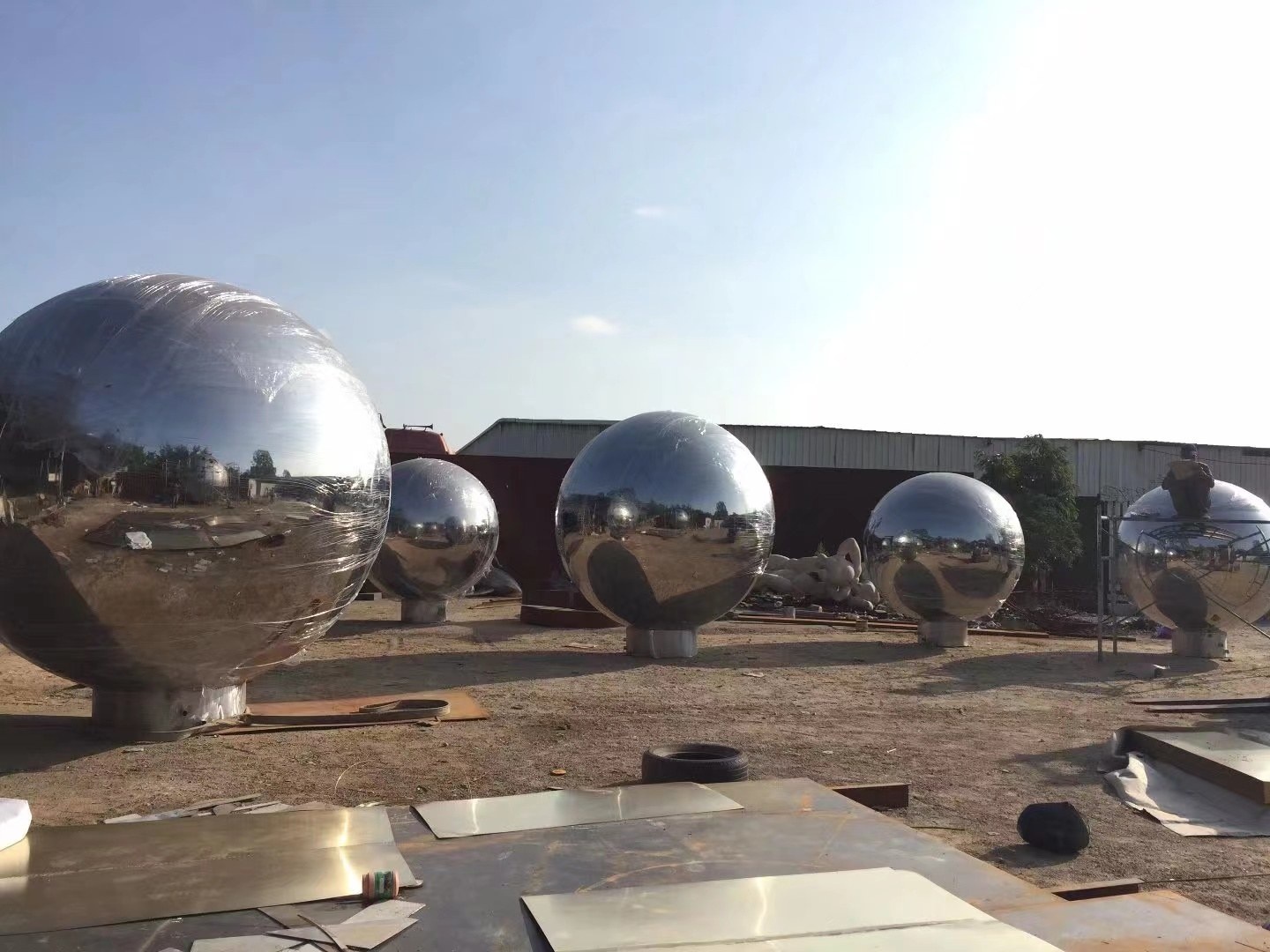 Installed mirror stainless steel sphere sculpture