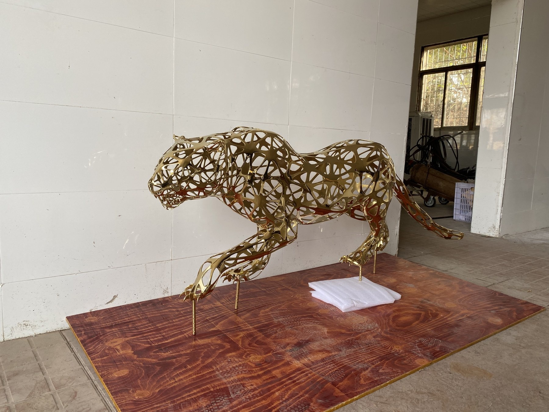 Second finished view of the same openwork leopard sculpture