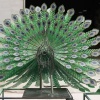 Painted metal peacock sculpture with open tail during workshop completion review