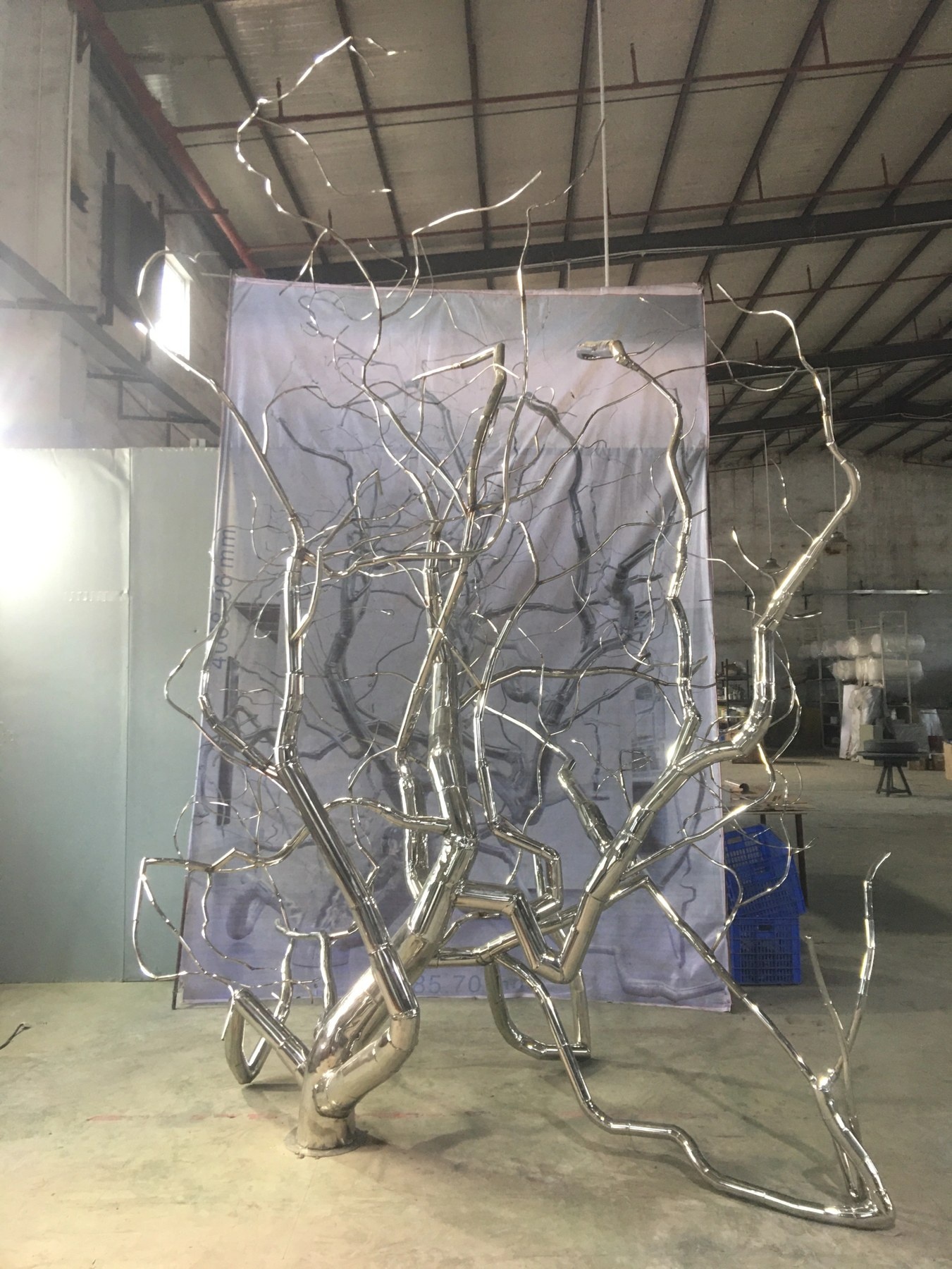 Second workshop angle of the same stainless steel branch sculpture and branching network