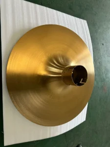 Brushed stainless steel part with a gold titanium (PVD) coating