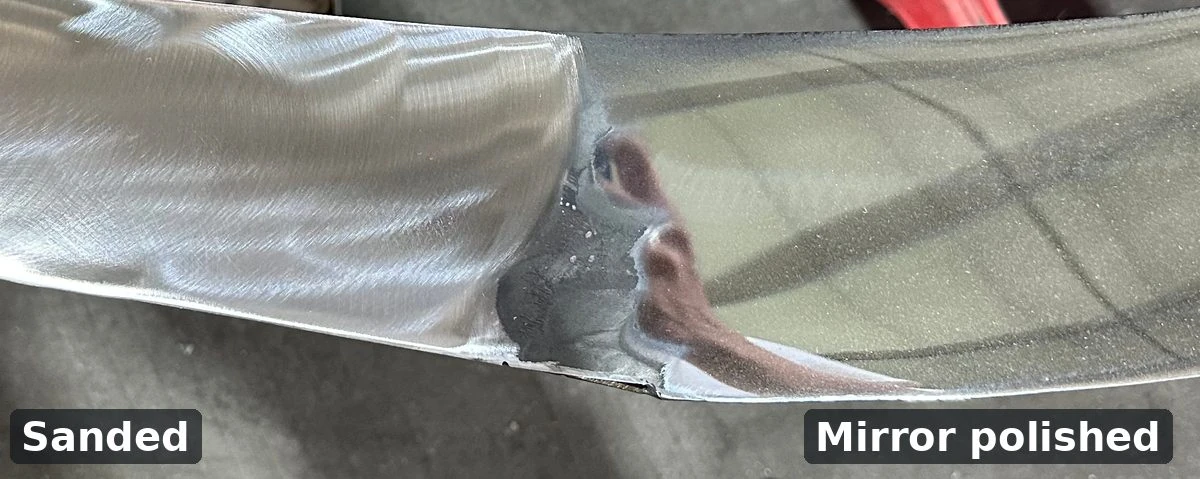 Stainless steel band with a sanded surface next to a mirror-polished surface