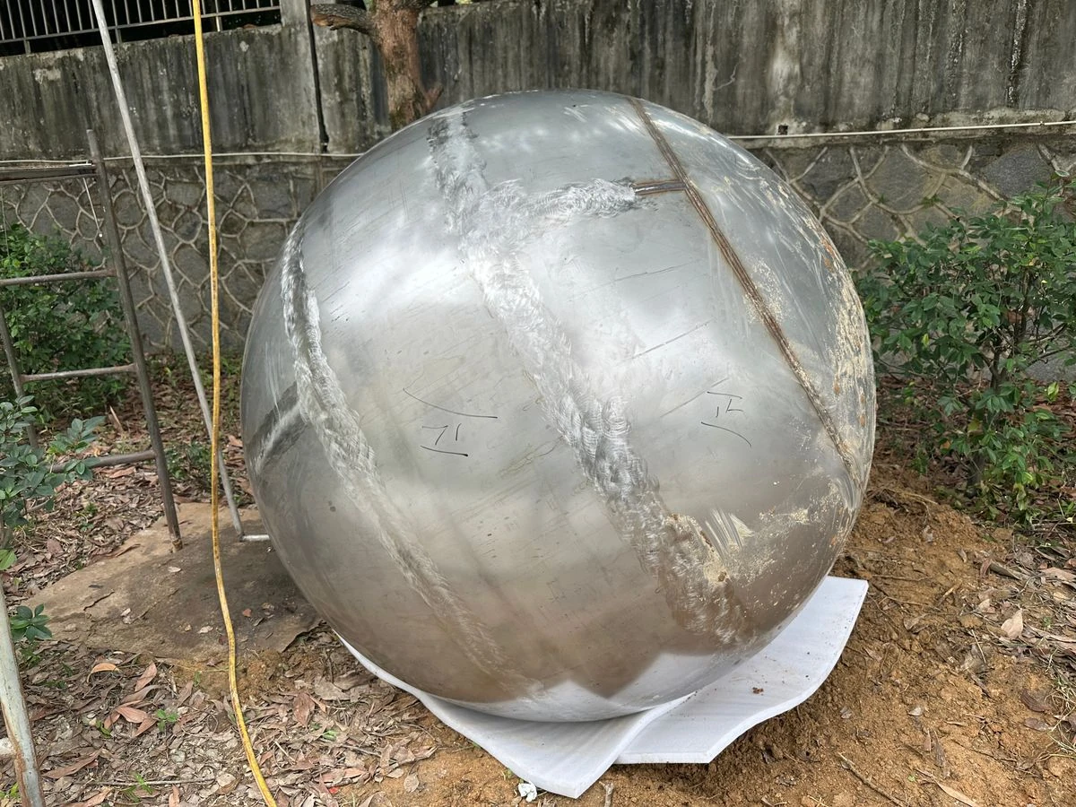 Stainless steel sphere after welding, with the weld seams ground flush before polishing